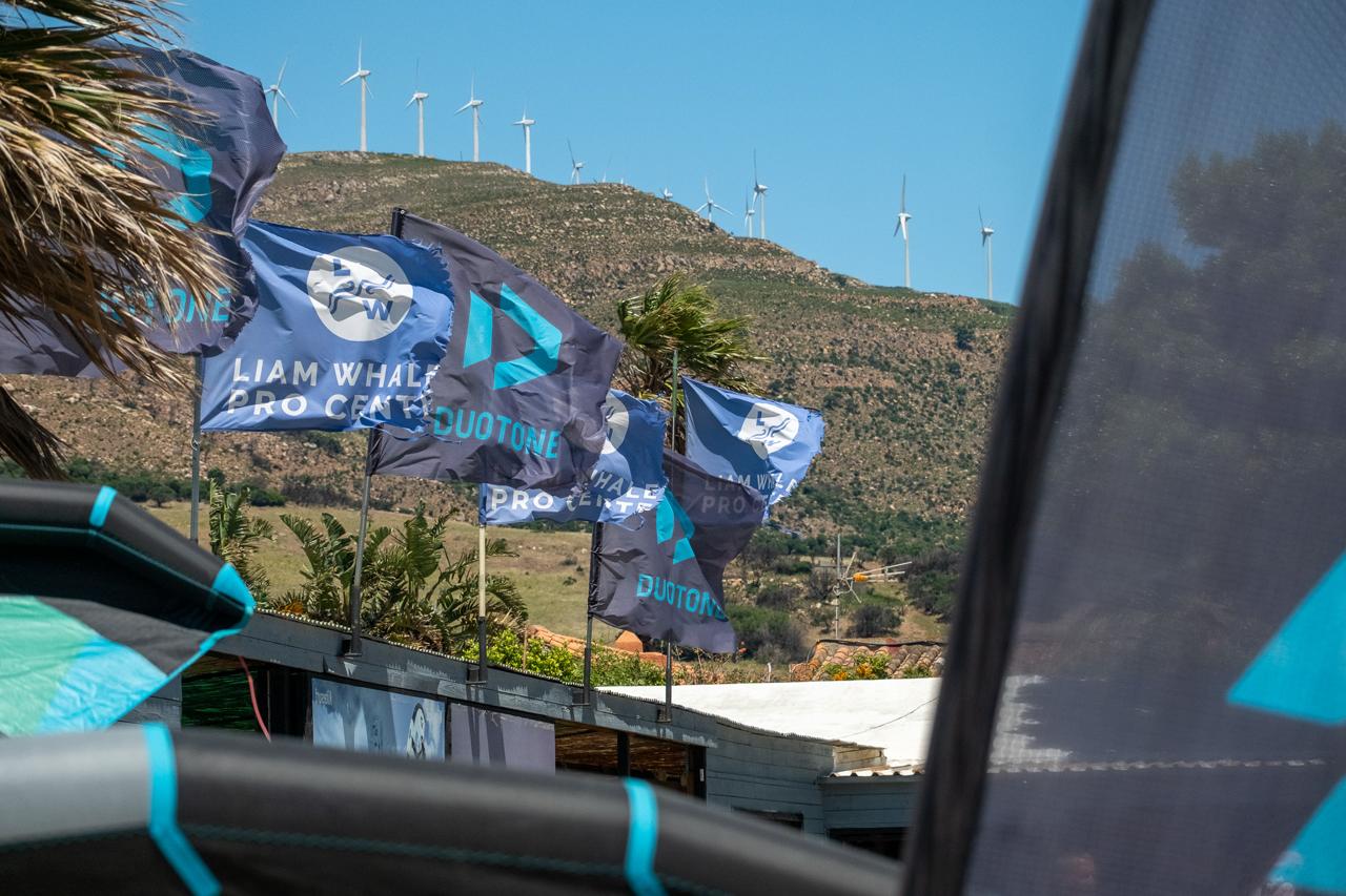 Liam Whaley Pro Center flags blowing in strong Levante wind at Valdevaqueros Beach, Tarifa